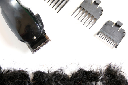Hairclipper electricity with hairs on a white background.