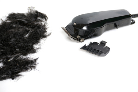 Hairclipper electricity with hairs on a white background.