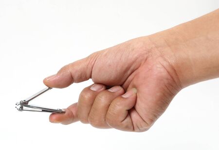 Man hand holding a nail clipper on a white background.の写真素材