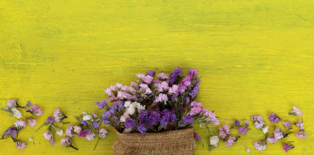 Beautiful flowers on yellow wood.の写真素材