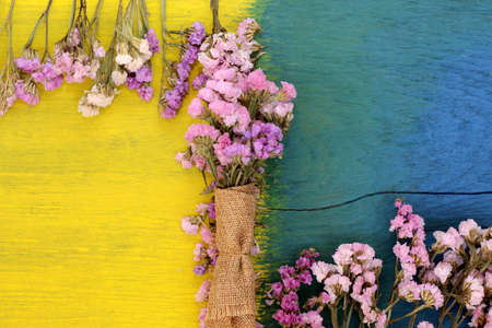 Beautiful flowers on the wooden floor, yellow and blue.の写真素材
