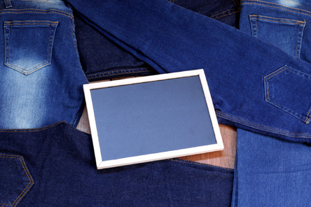 Jeans with a blackboard on the wooden floor.