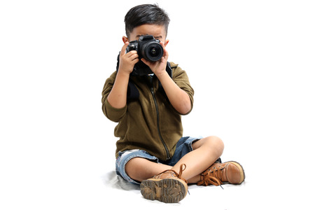 Asian boy using a camera on a white background.isolatedの写真素材
