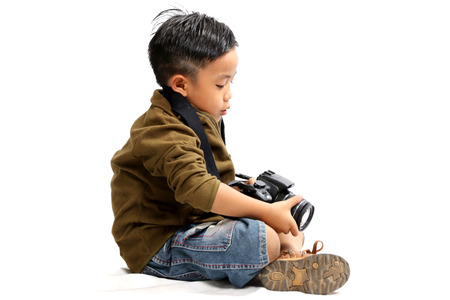 Asian boy using a camera on a white background.isolatedの写真素材
