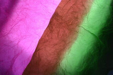 Texture of red,green and pink striped crumpled paper for pattern backgroundの写真素材