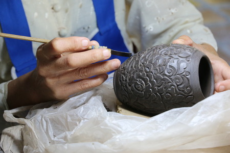 CHIANGMAI, THAILAND - OCTOBER 10, 2016 :Artist making and painting thai style clay sculpture at Chiangmai Celadon in Chiangmai Thailand.のeditorial素材