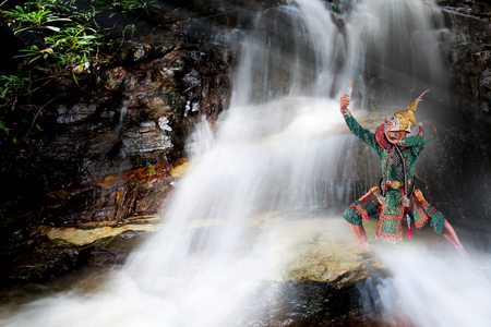 Art culture thailand dancing in masked khon hanuman Posing on the waterfall.の写真素材