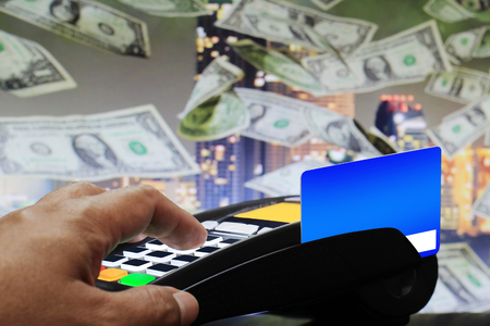 Male hand enters PIN code on payment terminalの写真素材