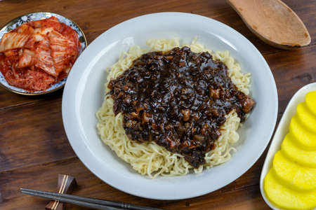 Korean traditional Noodles Jajangmyeon on wooden table, Korean Noodles in a black bean sauce with pork and mushroom.の写真素材