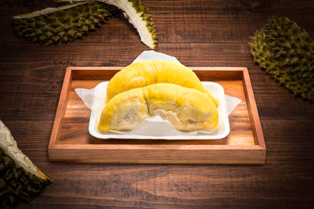 Durian the King of fruits, Durian fruit  on wooden background. durian fruit with delicious golden yellow soft fleshの写真素材