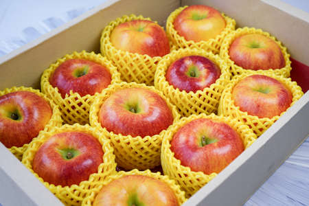 Fresh Red apple in packaging ready to sell, US. Red Envy apple in the packing box for shipping.の写真素材