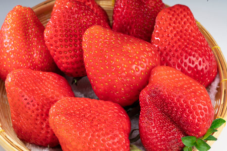 Fresh strawberries in a wooden basket on table, Red Strawberries in Bamboo basket on table.の写真素材