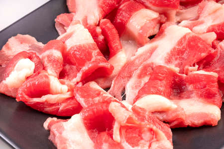 Sliced brisket beef on black plate, Sliced lean meat red beef on black background, Asian BBQ food styleの写真素材