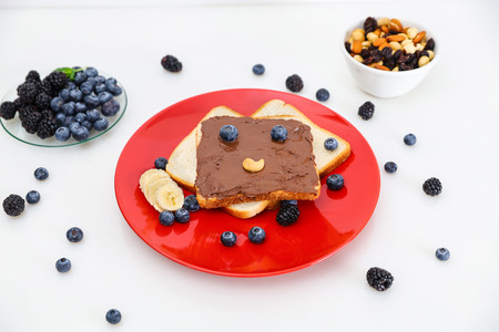 Toast with eyes and a smile. Toast with chocolate and nut paste.