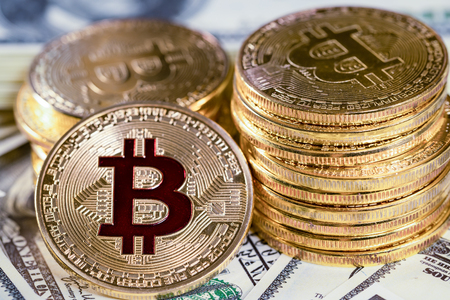 Pile bitcoin btc bit-coin lie on hundred-dollar bills of United States. Mining cryptocurrency.の写真素材