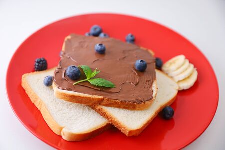 Toast with chocolate and nut paste and berry.の写真素材