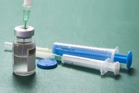 green background ampoule medical syringeの写真素材
