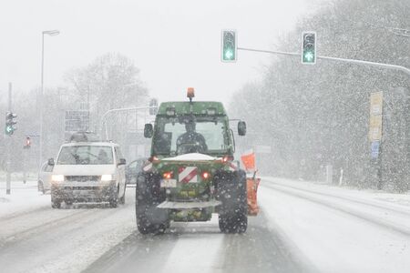 snowfall, snow-covered trail, problems of movement on the road. snow-removing tractorの写真素材