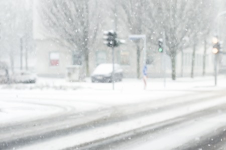 snowfall, snow-covered track, view from behind the wheel of the car, defocused lights of oncoming carsの写真素材
