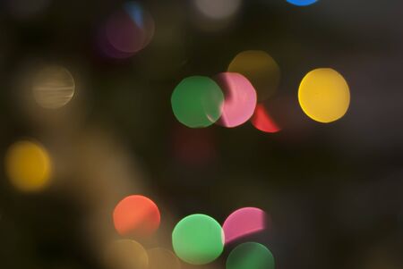 Colorful defocused bokeh lights background. Festive background with natural bokeh.の写真素材