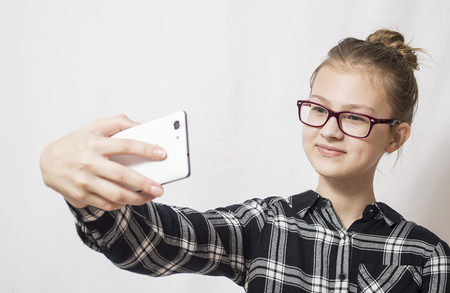 Smiling woman using a mobile phoneの写真素材