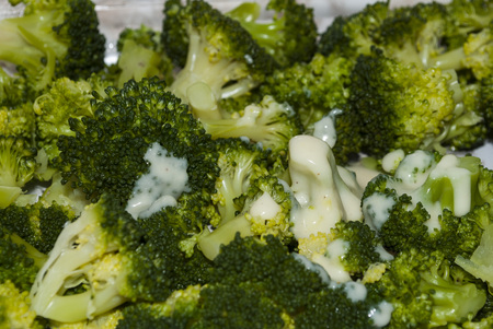 broccoli with sauce and grated cheese. cooking processの写真素材