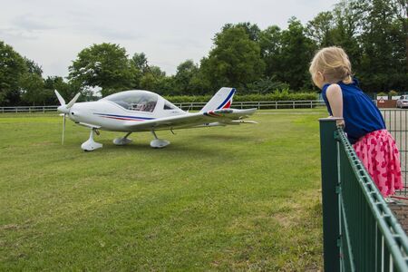 Airplane of white color, standing on the platform at sunset. Germany, Northern Westphalia, the city of Kamen. 06/29/2017のeditorial素材