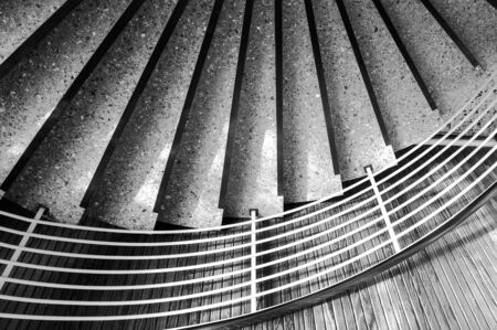 Spiral staircase with marble steps. Black white abstract background