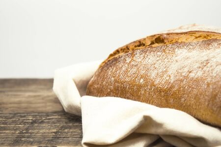 white, fresh bread of the Italian recipe on a wooden table. There is space for textの写真素材