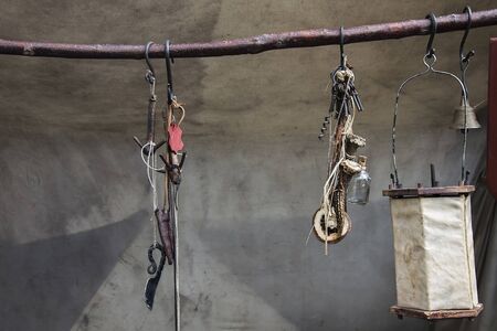 ancient products of leather and metal weighing on a wooden stick.の写真素材