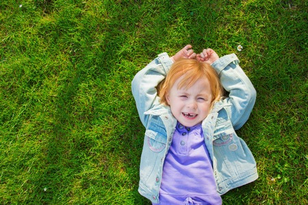 girl on the grass and laughingの写真素材
