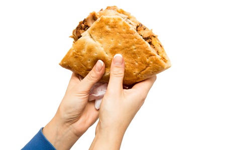 female hands holding a Turkish doner kebab, isolated object on a white backgroundの写真素材