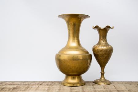 Vintage copper vase close-up, isolated on white background.staff on wooden surfaceの写真素材