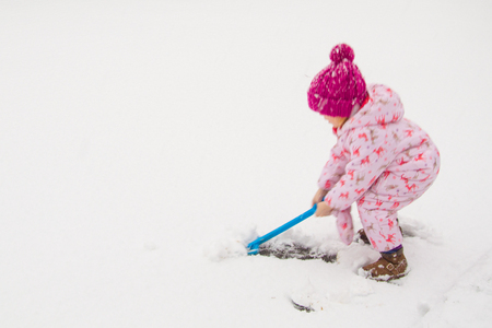first snow, children have fun on the street, making the first snowmanの写真素材