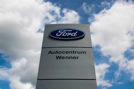 NRW, Germany 09/09/2018 Logo of the logo on the shield of the dealer. Against the blue sky. Ford Motor Company is an American multinational automaker. It was founded by Henry Ford.のeditorial素材