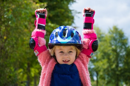 cheerful girl in a helmet and protection, outdoorsの写真素材