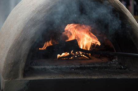 Firewood burns in a small stoveの写真素材