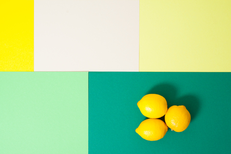 bright yellow lemons on green geometric backgroundの写真素材