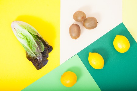fruits and vegetables on a bright background, lemon, lettuce, kiwi.