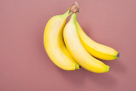 beautiful bananas on a pink background close-up.の写真素材