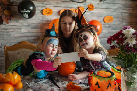 Children dressed in costumes celebrate Halloweenの写真素材