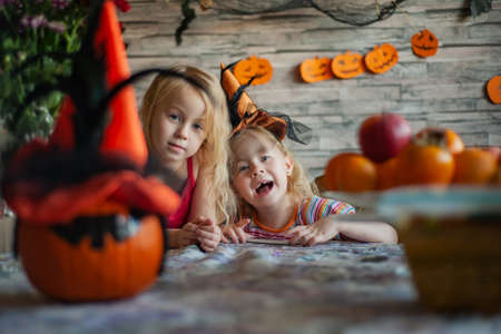children prepare pumpkin lantern before feast of all saintsの写真素材