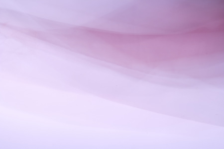 Abstract bright colorful fabric background in the form of a waveの写真素材