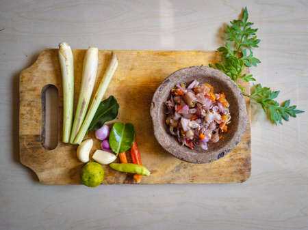 Indonesian Food squid with raw fresh sauce. (Cumi sambal matah), made from squid with indonesian sauce or sambal from bali with the name of raw sauce (sambal matah).の写真素材