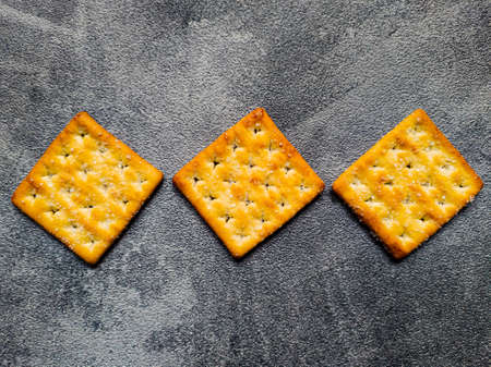 Three Sweet Crunchy Crackers  horizontal line isolated on abstract background. Flay Lay.の写真素材