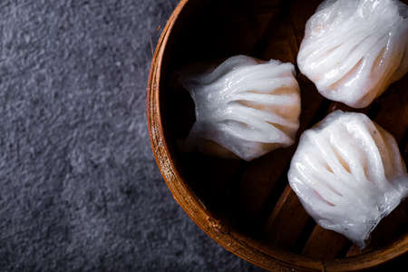 Dim Sum served in steamer baskets with dark backgroundsの写真素材