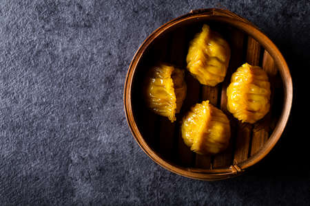 Dim Sum served in steamer baskets with dark backgroundsの写真素材