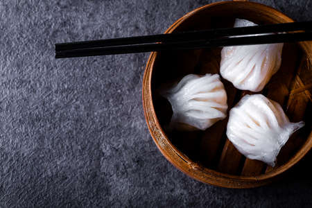 Dim Sum served in steamer baskets with dark backgroundの写真素材