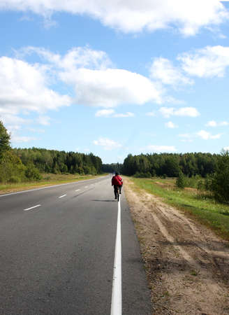 cyclist on country road rides at the markupの写真素材