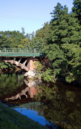arched bridge across the river at the Alexander Nevsky monastery of St. Petersburgの写真素材